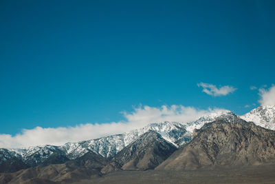 Scenic view of mountains against blue sky at death valley during winter