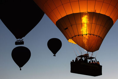 Low angle view of hot air balloons flying in sky