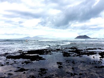 Scenic view of sea against cloudy sky