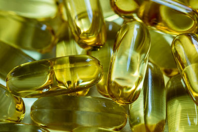 Close-up of cod liver oil capsules on table