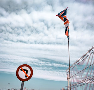 Information sign board by sea against sky