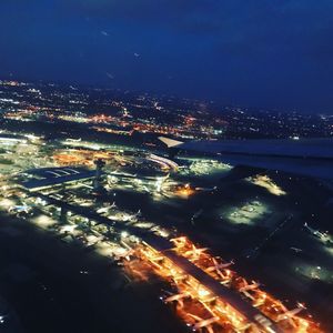 High angle view of city lit up at night