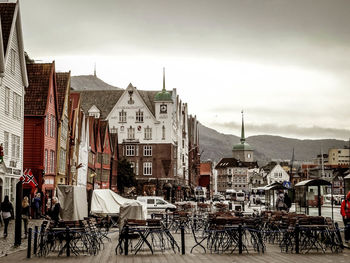 Bicycles on table in city against sky