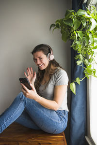 Smiling portrait of individual woman facetiming from home