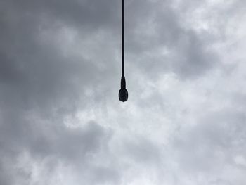 Low angle view of street light against cloudy sky