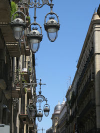 Low angle view of street light against buildings