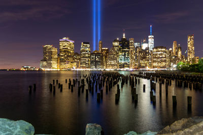 Illuminated city at waterfront