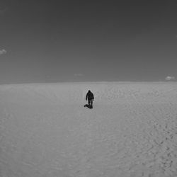 Man in snow against clear sky