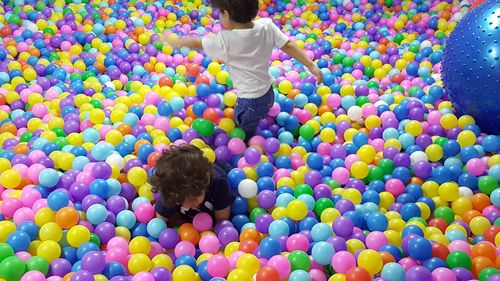 Rear view of boy playing with ball