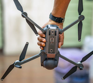 Close-up of man holding drone. 