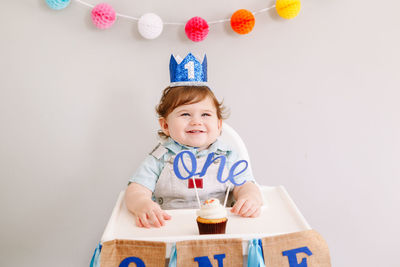 Cute baby boy against wall