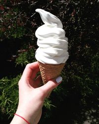 Close-up of hand holding ice cream cone