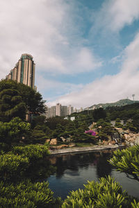 Scenic view of lake by buildings against sky