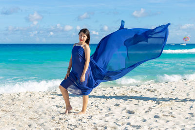 Full length of young woman on beach