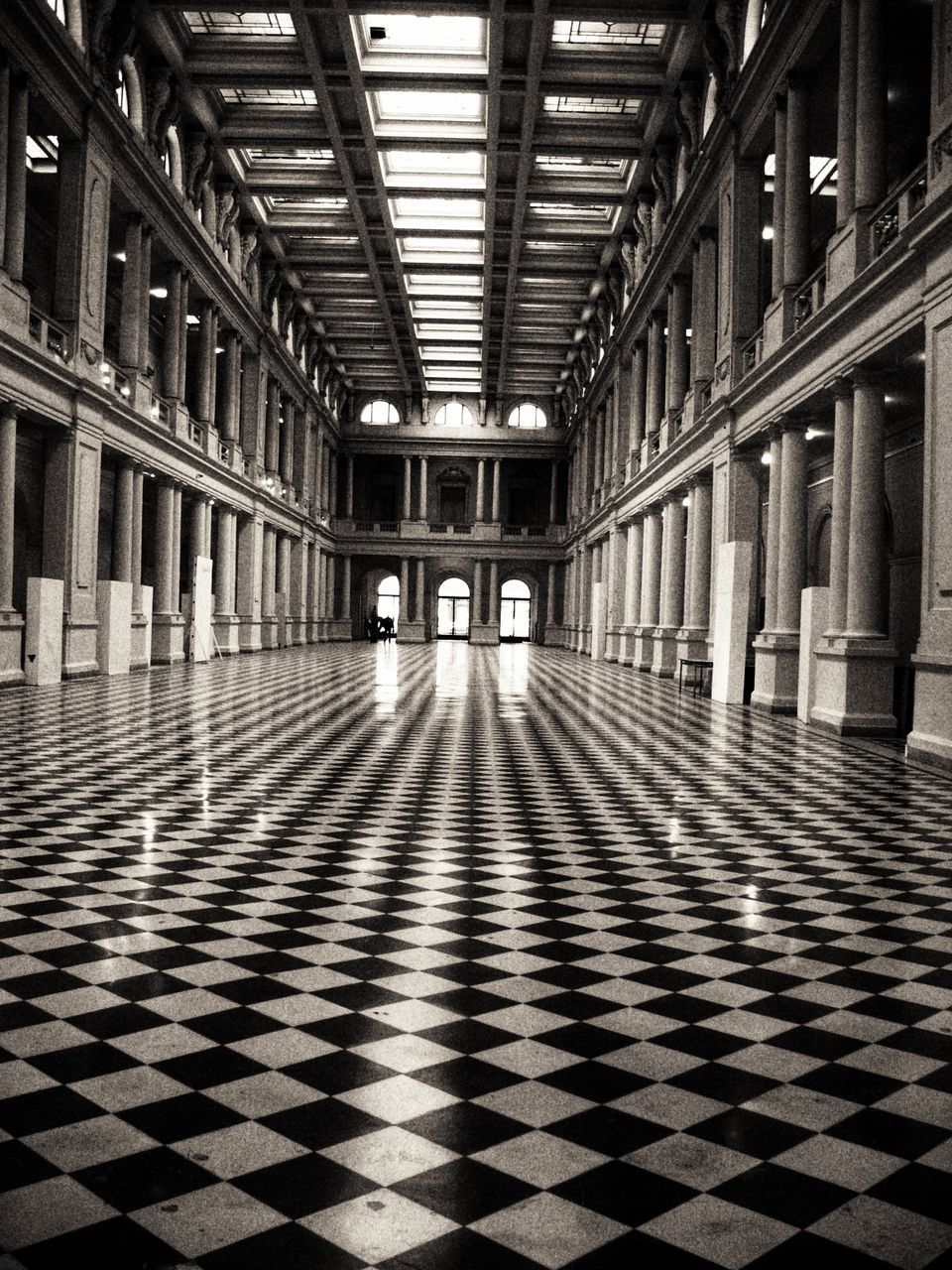 architecture, flooring, indoors, pattern, checked pattern, tile, tiled floor, building, built structure, corridor, arcade, no people, lighting equipment, the way forward, diminishing perspective, illuminated, ceiling, direction, architectural column, window, luxury, colonnade, electric lamp