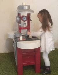 Side view of young woman standing at home