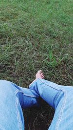 Low section of person relaxing on land