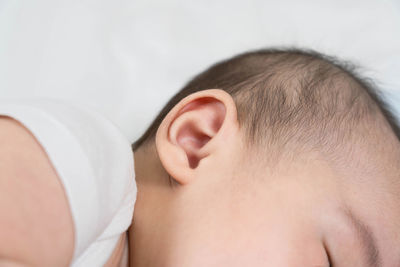 Close-up of boy sleeping on bed