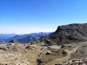 Scenic view of mountains against clear blue sky