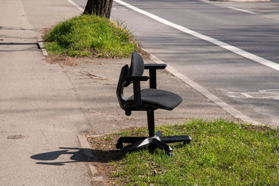 Empty bench on road