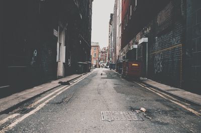 Road amidst buildings in city