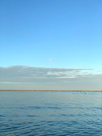 Scenic view of sea against blue sky