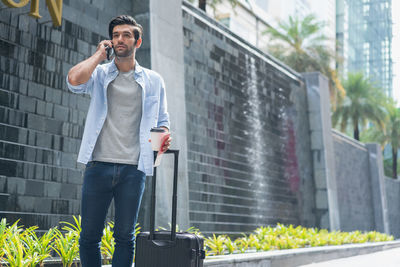 Full length of young man standing in city