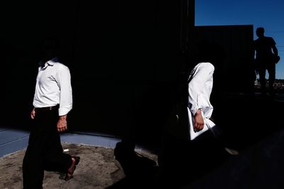 Rear view of man and woman standing at home