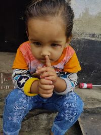 Portrait of cute girl holding baby