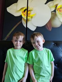 Portrait of smiling siblings on sofa