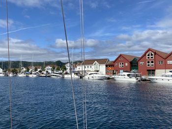 Arriving via sailboat to the marina in farsund, norway on a sunny day.