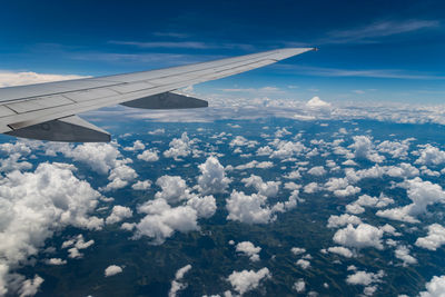 Aerial view of aircraft wing against sky