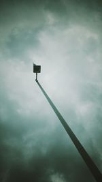 Low angle view of street light against cloudy sky