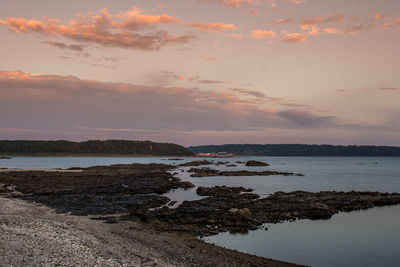 Scenic view of sea against sky at sunset