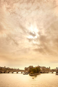 Sky with rising sun over ile de la cite, seine river, paris, france