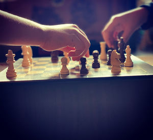 Low angle view of people playing on chess board