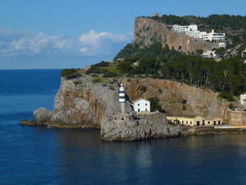 Lighthouse by sea against sky porto soller, majorca