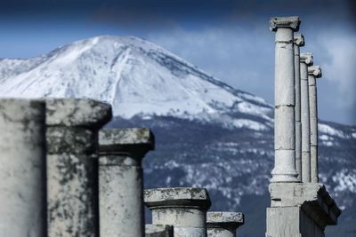 Low angle view of columns against sky