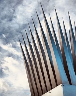 Low angle view of metal poles against sky