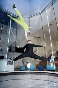 Man with woman flying in wind tunnel