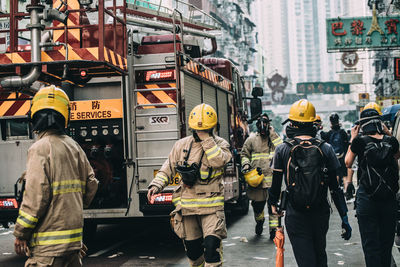 Rear view of people on street in city