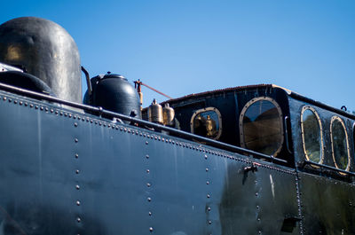 Low angle view of steam train against clear sky