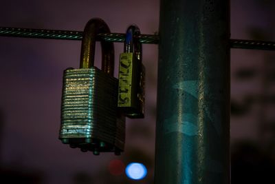 Close-up of illuminated metal against sky at night