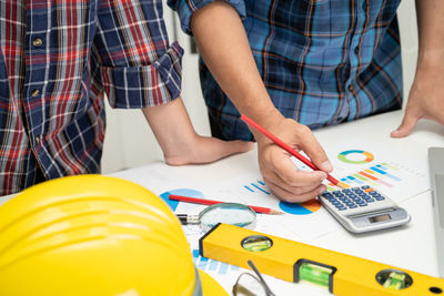 Midsection of architects working at office