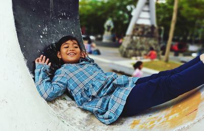 Portrait of happy boy with arms raised