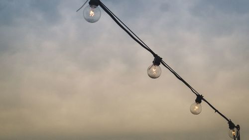 Low angle view of light bulb against sky