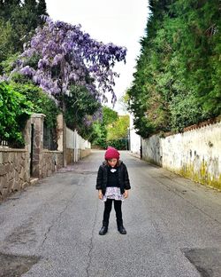 Portrait of girl sticking out tongue standing on road