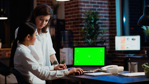 Young woman using laptop at office