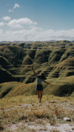 Rear view of woman walking on mountain