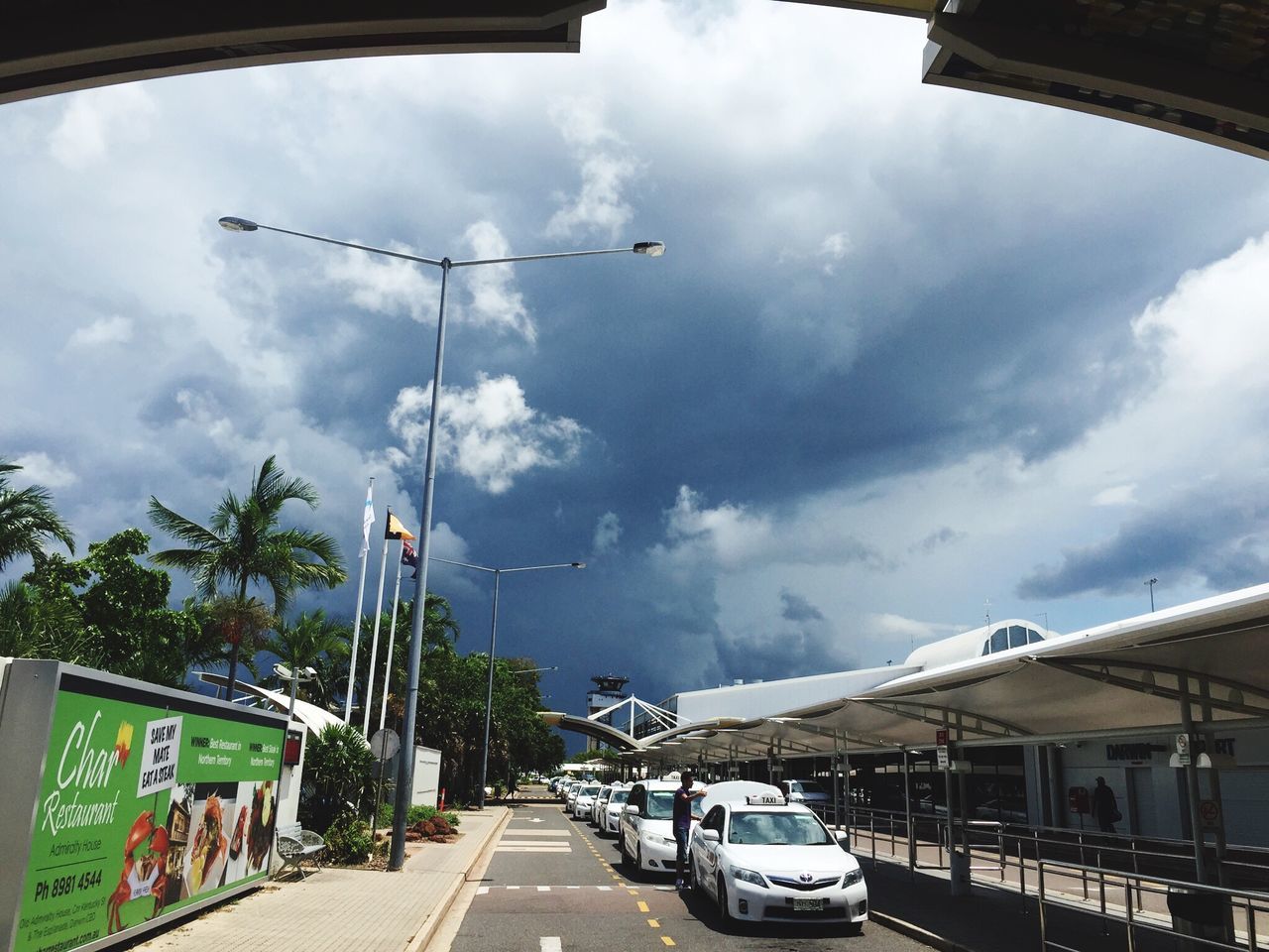 sky, cloud - sky, transportation, cloudy, built structure, architecture, building exterior, the way forward, mode of transport, car, road, street, cloud, land vehicle, street light, diminishing perspective, weather, overcast, outdoors, vanishing point